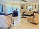 Elegant living room featuring decorative furniture, a cozy fireplace, and soft, natural light at 1516 Arrowhead Dr, Sun City Center, FL 33573