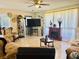 Cozy living room with classic furnishings, a large television, and a decorative fireplace at 1516 Arrowhead Dr, Sun City Center, FL 33573