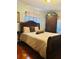 Inviting main bedroom with a comfortable bed, classic furniture, and hardwood flooring at 1516 Arrowhead Dr, Sun City Center, FL 33573