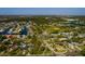 An aerial view of a waterfront community with canals, lush greenery, and a baseball field under a clear blue sky at 1591 N Dakota Ne Ave, St Petersburg, FL 33703
