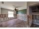 Bedroom under renovation with wood-look flooring, exposed walls, ceiling fan and natural light at 1591 N Dakota Ne Ave, St Petersburg, FL 33703