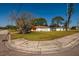 Front lawn of the property shows the home with its surrounding grassy area and street corner curb at 1591 N Dakota Ne Ave, St Petersburg, FL 33703