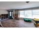 Living room with wood floors, a large window, and evidence of work in progress around the room at 1591 N Dakota Ne Ave, St Petersburg, FL 33703
