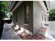 Exterior view of a home featuring a paved walkway, windows, and a side door, complemented by greenery at 1619 San Roy Dr, Dunedin, FL 34698