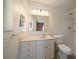 An updated bathroom with a white vanity, and a glass shower at 1651 Summit Way, Dunedin, FL 34698