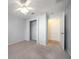 Neutral bedroom featuring a carpet, closet and doorway leading to wood flooring at 1651 Summit Way, Dunedin, FL 34698