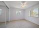 Bedroom with carpeted floor, fan, and large windows offering abundant natural light at 1651 Summit Way, Dunedin, FL 34698