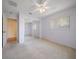 Light-filled bedroom with neutral carpet, sliding closet doors, and large windows at 1651 Summit Way, Dunedin, FL 34698