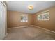A cozy bedroom with carpet, two windows with blinds, and a closet at 1651 Summit Way, Dunedin, FL 34698