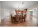 An open concept kitchen and dining area with wood cabinets, light countertops, and a wooden dining table at 1651 Summit Way, Dunedin, FL 34698