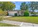 Charming single-story home with a well-manicured lawn and mature trees for added curb appeal at 1651 Summit Way, Dunedin, FL 34698