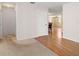 Open-concept living area showcasing carpet, hardwood, and a view into the dining room at 1651 Summit Way, Dunedin, FL 34698