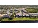 Aerial view of yard and townhome, featuring a community pool and canal access, great for outdoor living at 1806 Lago Vista Blvd, Palm Harbor, FL 34685