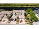 Gorgeous aerial view of a townhome with beautiful tile roof, garage and canal front location with mature landscaping at 1806 Lago Vista Blvd, Palm Harbor, FL 34685