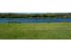 Well maintained back lawn overlooking a canal; featuring a lush green landscape at 1806 Lago Vista Blvd, Palm Harbor, FL 34685