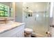 Clean bathroom with marble vanity, glass shower, and neutral tones at 1806 Lago Vista Blvd, Palm Harbor, FL 34685