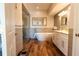 Modern bathroom featuring a soaking tub, glass-enclosed shower, and white marble-top vanity at 1806 Lago Vista Blvd, Palm Harbor, FL 34685