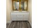 Bright bathroom featuring a double sink vanity with marble countertop and ample cabinet space at 1806 Lago Vista Blvd, Palm Harbor, FL 34685