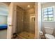 Elegant bathroom featuring a glass-enclosed shower, tiled walls, and modern fixtures at 1806 Lago Vista Blvd, Palm Harbor, FL 34685