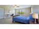 Cozy bedroom with a desk, large window, and lush outdoor views at 1806 Lago Vista Blvd, Palm Harbor, FL 34685