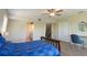 Bedroom with ceiling fan, ensuite bathroom, closet, and a desk area at 1806 Lago Vista Blvd, Palm Harbor, FL 34685