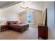 Bedroom featuring a vaulted ceiling, a large window, and neutral carpet at 1806 Lago Vista Blvd, Palm Harbor, FL 34685
