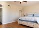Calm bedroom with white and blue bedding, hardwood floors, and neutral walls at 1806 Lago Vista Blvd, Palm Harbor, FL 34685