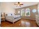 Bright bedroom with wood floors, a large window, and natural light at 1806 Lago Vista Blvd, Palm Harbor, FL 34685