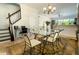 Bright dining room featuring a glass table, six chairs, and adjacent living area with natural light at 1806 Lago Vista Blvd, Palm Harbor, FL 34685