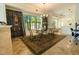Elegant dining room featuring a glass table, modern chairs, sophisticated decor, and natural light at 1806 Lago Vista Blvd, Palm Harbor, FL 34685