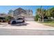 Charming two-story townhome with a well-manicured lawn and a spacious two-car garage and red paved driveway at 1806 Lago Vista Blvd, Palm Harbor, FL 34685