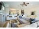Bright living room with modern furniture open to the dining area and featuring a stylish bar at 1806 Lago Vista Blvd, Palm Harbor, FL 34685