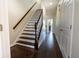 Staircase with dark wood steps and white risers, leading to the upper level at 1806 Lago Vista Blvd, Palm Harbor, FL 34685