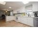 This kitchen features white cabinets and appliances, and white countertops at 186 Blue Marlin Dr, Oldsmar, FL 34677