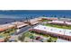 Aerial view of community buildings by the water with covered parking, landscaping, and a view of the bay at 19029 Us Highway 19 N # 27A, Clearwater, FL 33764