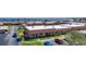 Aerial view showcases the condo community with covered parking, lush landscaping, and views of the waterfront at 19029 Us Highway 19 N # 27A, Clearwater, FL 33764