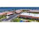 Aerial view of the condo community showing the buildings, parking areas, mature landscaping, and waterfront location at 19029 Us Highway 19 N # 27A, Clearwater, FL 33764