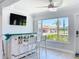 Charming bar space featuring a white wooden bar with white stools and beach-themed decor, filled with natural light at 19029 Us Highway 19 N # 27A, Clearwater, FL 33764