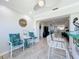 Bar area with white chairs and table, leading to living room and hallway at 19029 Us Highway 19 N # 27A, Clearwater, FL 33764