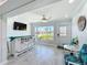Cozy bar area with light color palettes featuring a wooden counter, white stools, and a charming beach theme at 19029 Us Highway 19 N # 27A, Clearwater, FL 33764