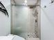 Modern bathroom with a sleek, glass-enclosed shower featuring gray and white tiles and a dual shower head at 19029 Us Highway 19 N # 27A, Clearwater, FL 33764