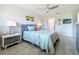 Comfortable bedroom with tile floors, ceiling fan, and beach-themed decor at 19029 Us Highway 19 N # 27A, Clearwater, FL 33764