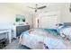 Bedroom featuring tile floors, a ceiling fan, a closet, coastal decor, and natural light at 19029 Us Highway 19 N # 27A, Clearwater, FL 33764
