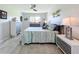 Comfortable bedroom with tile floors, ceiling fan, and beach-themed artwork at 19029 Us Highway 19 N # 27A, Clearwater, FL 33764