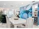 Dining area with a white table, modern artwork, and open floor plan at 19029 Us Highway 19 N # 27A, Clearwater, FL 33764