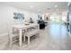 Open dining area with a white table, bench seating, and modern decor at 19029 Us Highway 19 N # 27A, Clearwater, FL 33764