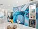 Close up of Dining area with a white table, modern artwork, and built-in drink cooler at 19029 Us Highway 19 N # 27A, Clearwater, FL 33764