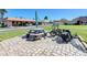 View of the outdoor picnic table, bicycles, and landscaped grounds of this condo complex at 19029 Us Highway 19 N # 27A, Clearwater, FL 33764