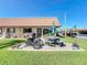 Charming condo with a red tile roof, brick patio, outdoor seating and a view of a manicured lawn at 19029 Us Highway 19 N # 27A, Clearwater, FL 33764