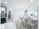 Open kitchen featuring white cabinets, a breakfast bar, and modern lighting at 19029 Us Highway 19 N # 27A, Clearwater, FL 33764